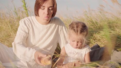 Mother with Children Lunch on Nature with Bread and Milk