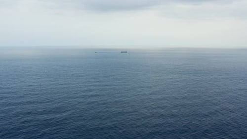 Tugboat tows ship in ocean