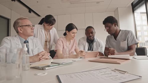 Medical Team Collaborating on Patient Care in Meeting