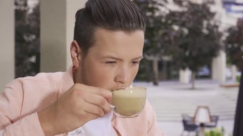 Young man using computer in cafe.