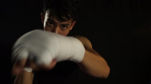 Young Boxer Punching Towards the Camera