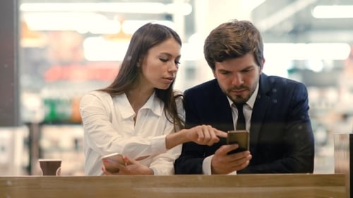 Professionals Using Cell Phones During Business Meeting
