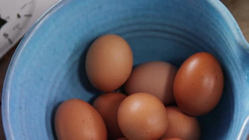 Brown eggs and flour on wooden table 4k