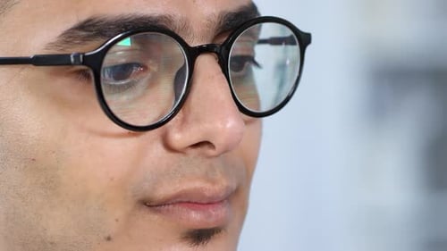 Middle Eastern Man Reading Data on Smart Glasses
