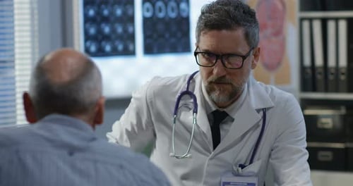 Male Doctor Consulting with Patient