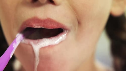 Girl brushing her teeth in bathroom 4k