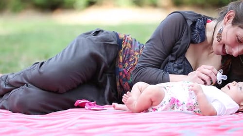Mother with her baby daughter at park spending some quality time together