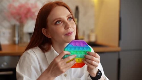 Young Woman Playing With Colorful Fidget Toy