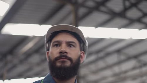 Engineer worker wearing protective eyeglasses walking in the industrial factory