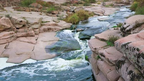 A Small Shining Stream Flows Among Smooth Wet and Dark Stones