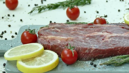 Fresh Raw Steak with Rosemary and Tomatoes