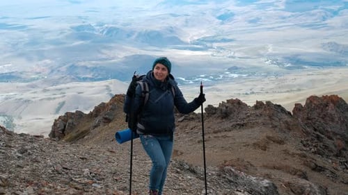 Young Woman Traveler Enjoying Hiking in Mountains