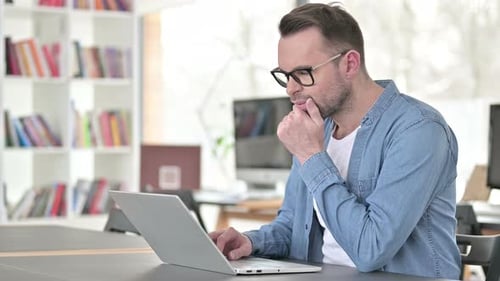 Man at Laptop in Office with Denim Shirt