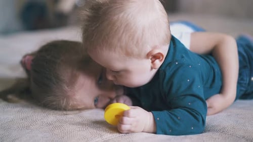 Sweet Siblings Playing Together on Bed Indoors