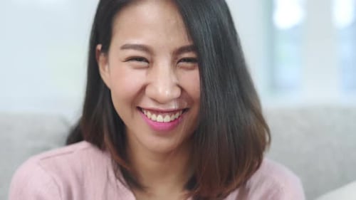 Smiling Young Adult Woman Looking at Camera