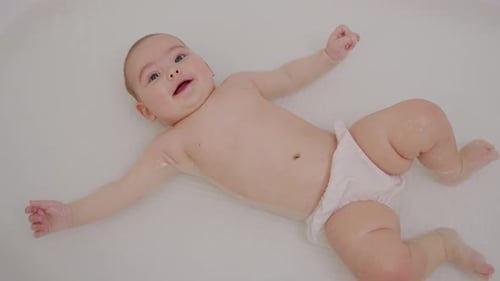 Baby Close Up Playing in Bath