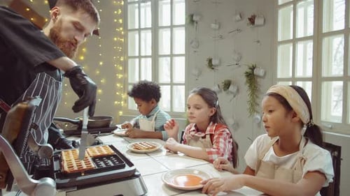 Chef Prepares Waffles for Children in Kitchen