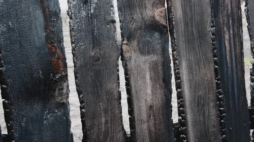 Burnt Fence Boards After a Fire in a Private House
