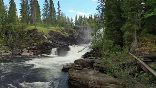 Waterfall Cascading Through Forest Landscape