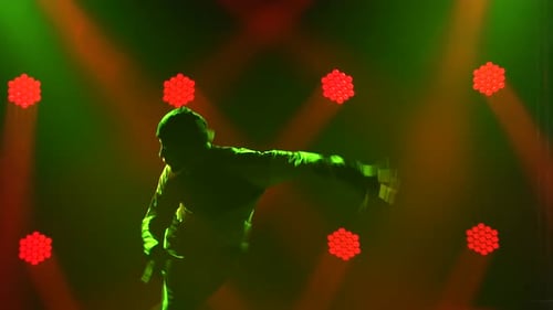 Silhouette of a Talented Young Break Dancer. Hip Hop Street Dance on a Stage in Front of the