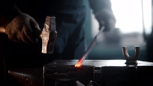 Blacksmith Workshop a Man Hits a Heated Metal Detail with a Hammer