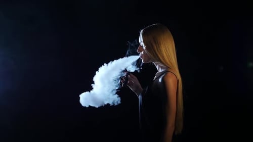 Stylish Woman Vaping Against a Crimson Backdrop, People Stock Footage ft. vape & young adult - Envato Stylish Woman Vaping Against a Crimson Backdrop, People Stock Footage ft. vape & young adult - Envato