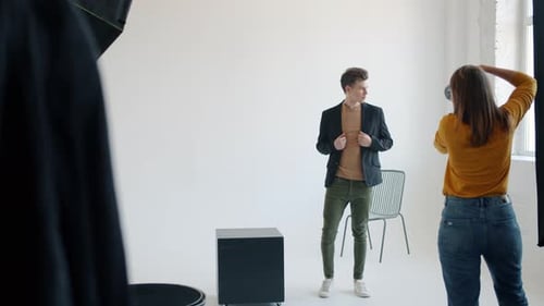 Attractive Young Man Posing for Camera Working with Photographer in Studio