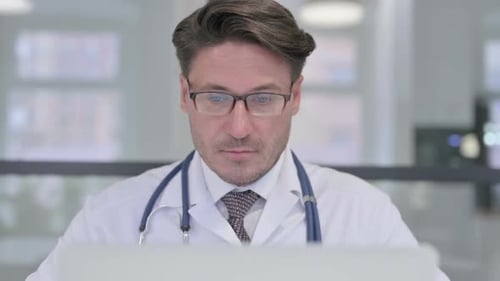 Close Up of Doctor Working on Laptop