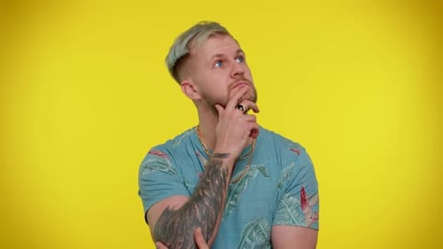 Man Thinking Deeply Against Yellow Background