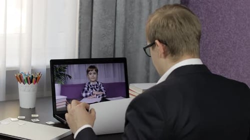 Man and Child on Laptop Video Call