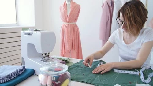 Smiling Woman Sewing in Bright Studio