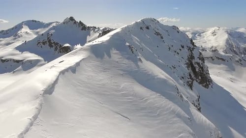 Aerial View of Snowy Mountain Range in Winter