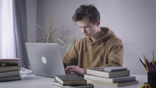 Diligent Caucasian College Student Closing Laptop and Sighing. Portrait of Genius Brunette Boy