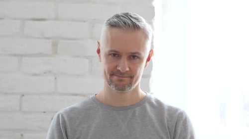 Shaking Head to No, Rejecting Middle Aged Man Sitting in Office