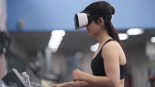 Side View Smiling Positive Sportswoman Putting on VR Headset Start Running on Treadmill
