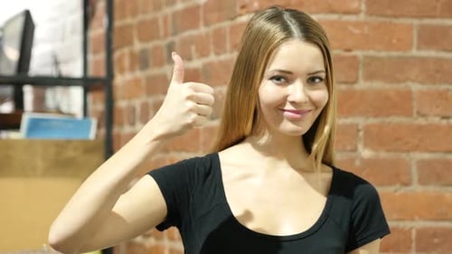 Young Woman Thumbs Up Approval in Office