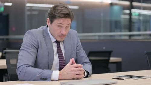 Thoughtful Businessman in Modern Office Environment