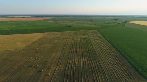 Aerial View Hay Bales at Agricultural Field in Summer at Sunset Haystack
