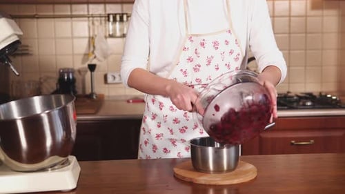 Woman Preparing Red Berries in Kitchen