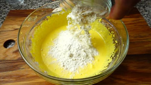 Flour Being Added To Batter in Bowl