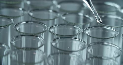 Dropper Dispensing Liquid into Clear Test Tubes