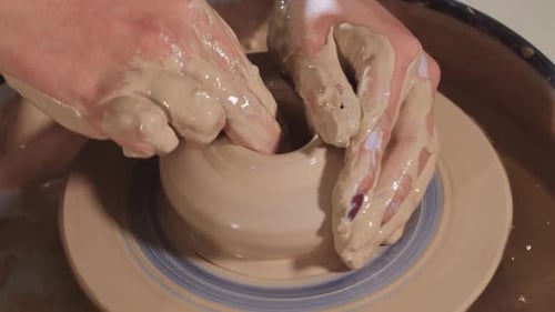 Hands Shaping Clay on a Pottery Wheel