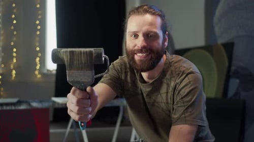 Happy Artist Holding Brush in Art Studio