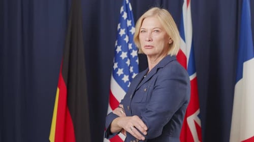 Woman Stands Proudly Before International Flags