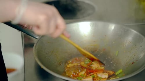 Chef Cooking Stir Fry in a Restaurant Kitchen