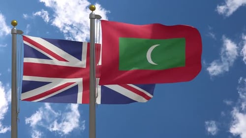 United Kingdom and Maldives National Flags Waving Against Blue Sky