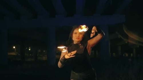 Woman Performing Dynamic Fire Dance at Night