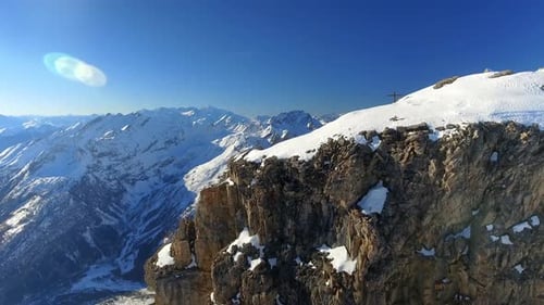 Mountain Peak and Steep Snowy Valley