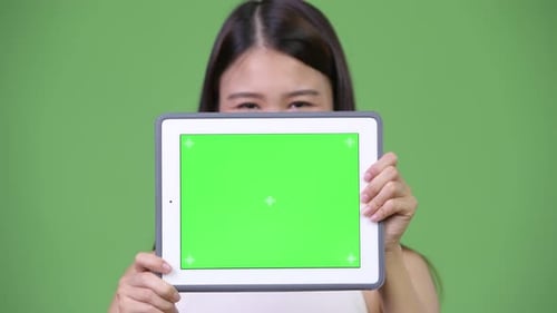 Woman Holds Tablet with Green Screen for Compositing