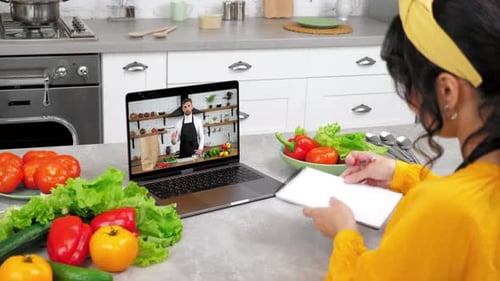 Woman Attending Online Cooking Class in Kitchen